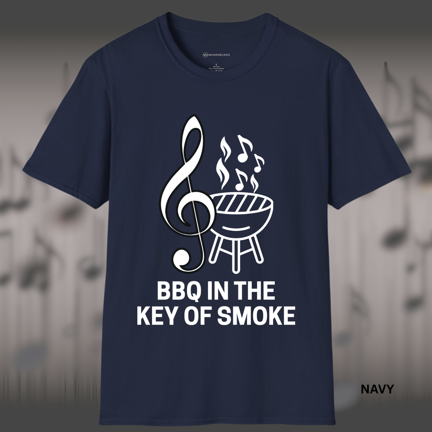 Design featuring a large white treble clef beside a charcoal grill emitting smoke shaped like music notes, with bold text below reading “BBQ IN THE KEY OF SMOKE.”