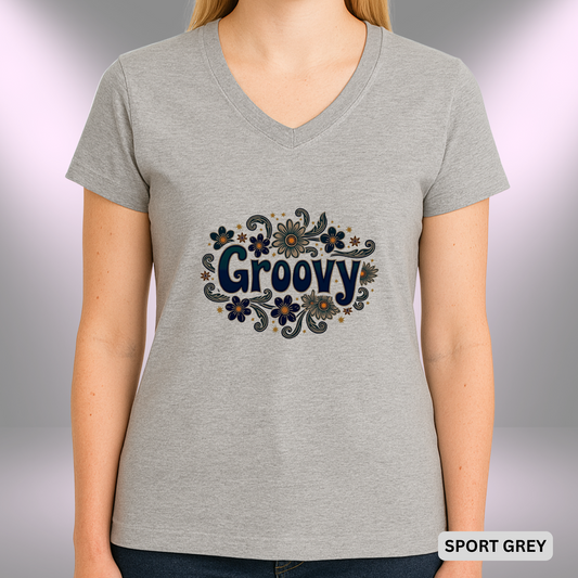A retro-inspired “Groovy” design featuring navy and teal lettering surrounded by swirling daisy flowers and golden star accents, all styled in a 1970s floral motif.

