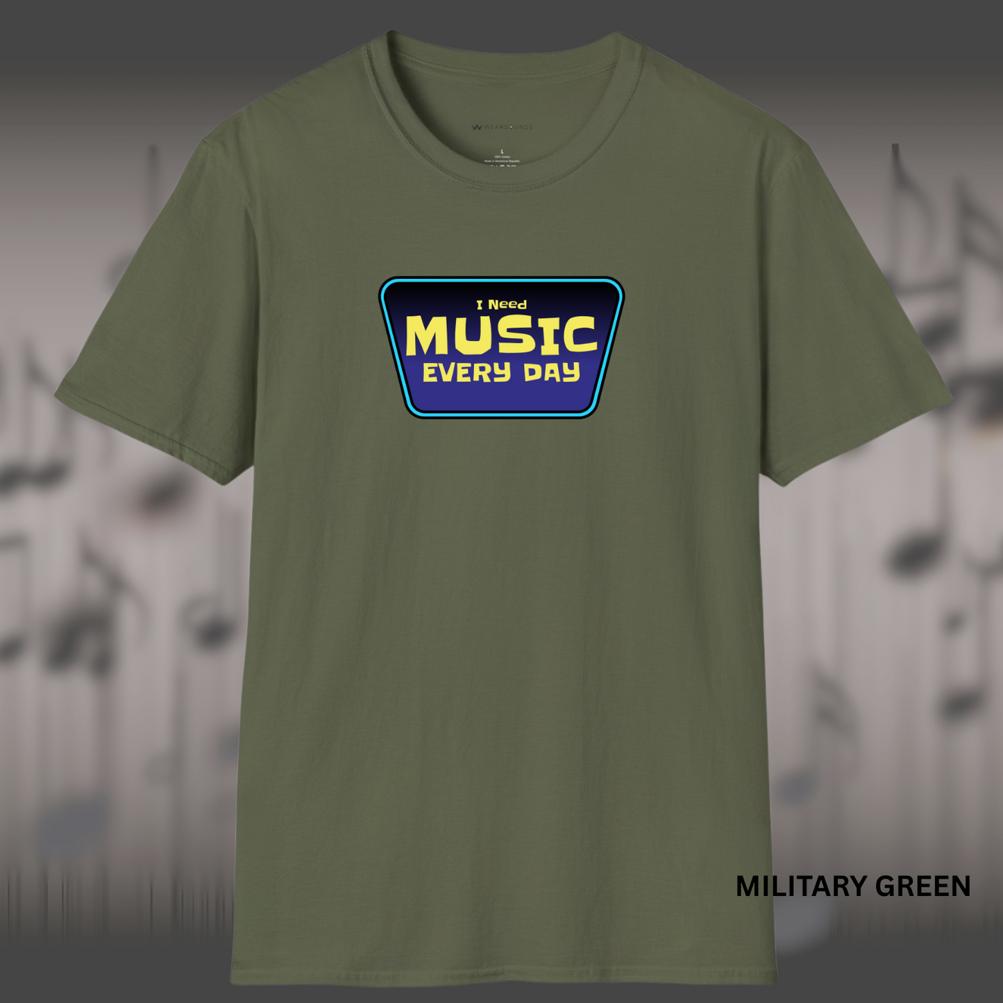 A trapezoid-shaped badge with the words “I Need MUSIC EVERY DAY” in bold yellow letters on a purple background, outlined in electric blue.