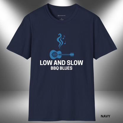 Stylized graphic of a blue acoustic guitar with grill grates over the sound hole, rising smoke shaped like music notes above it. The text “LOW AND SLOW BBQ BLUES” appears below in bold white lettering on a black background.