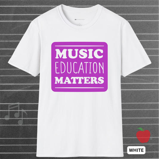 White t-shirt with 'Music Education Matters' in purple on a gray background with musical notes and an apple icon.